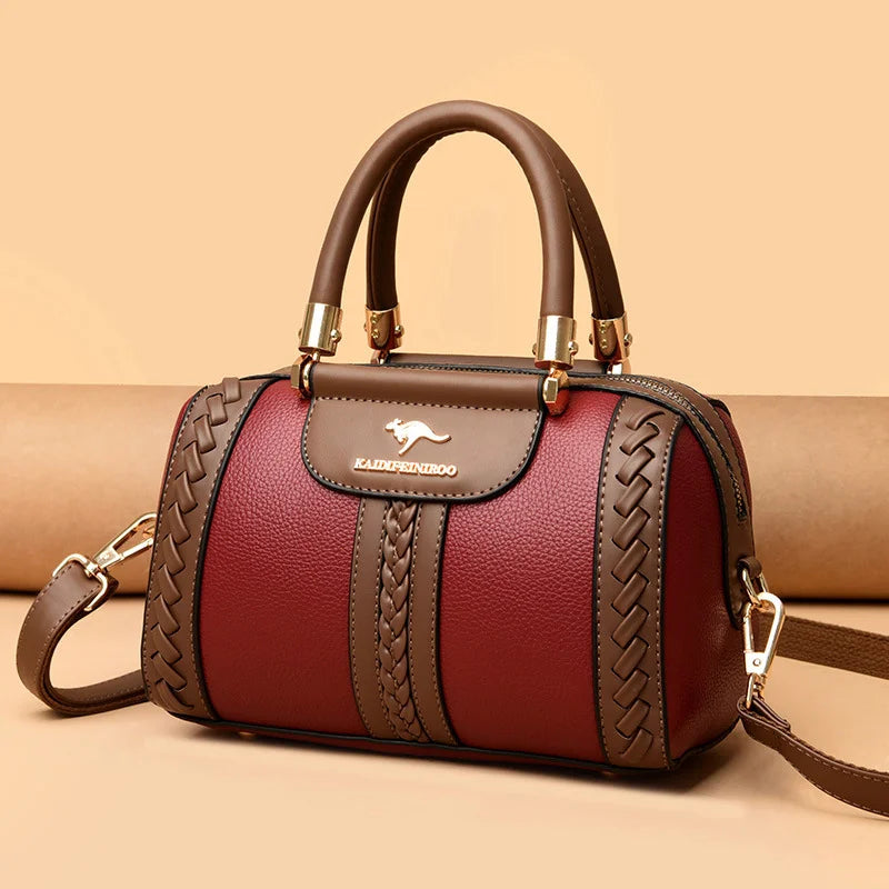 Brown and red handbag with braided details on a beige background
