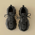 Pair of black sneakers on a beige background