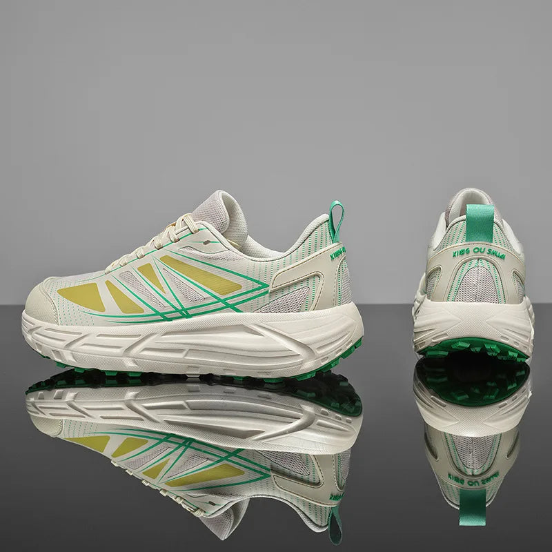 A pair of chunky athletic sneakers shown from the side and back on a reflective black surface against a gray studio background. The shoes are primarily off-white with green and pale yellow-green geometric side stripes and a green heel pull tab.