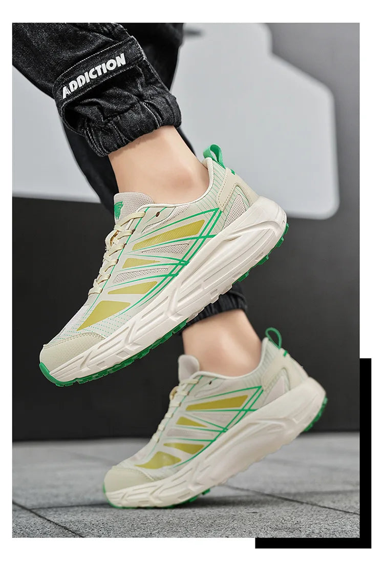 A pair of chunky low-top sneakers shown on a person's feet, with the lower legs and black cuffed pants visible. The shoes are off-white with lime green geometric side stripes and green outsole accents.
