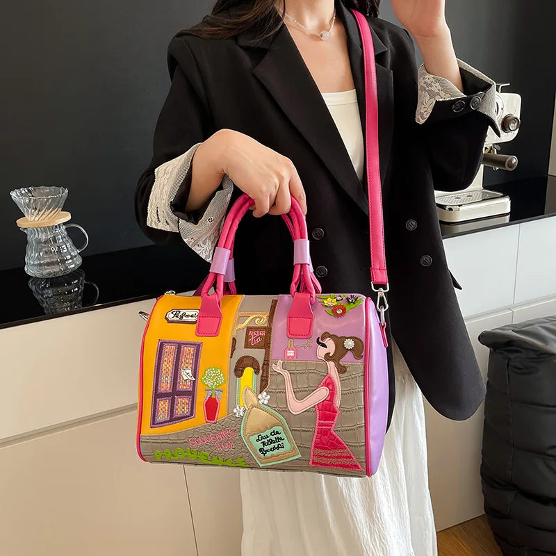 Person holding a colorful handbag with artistic design in a kitchen setting