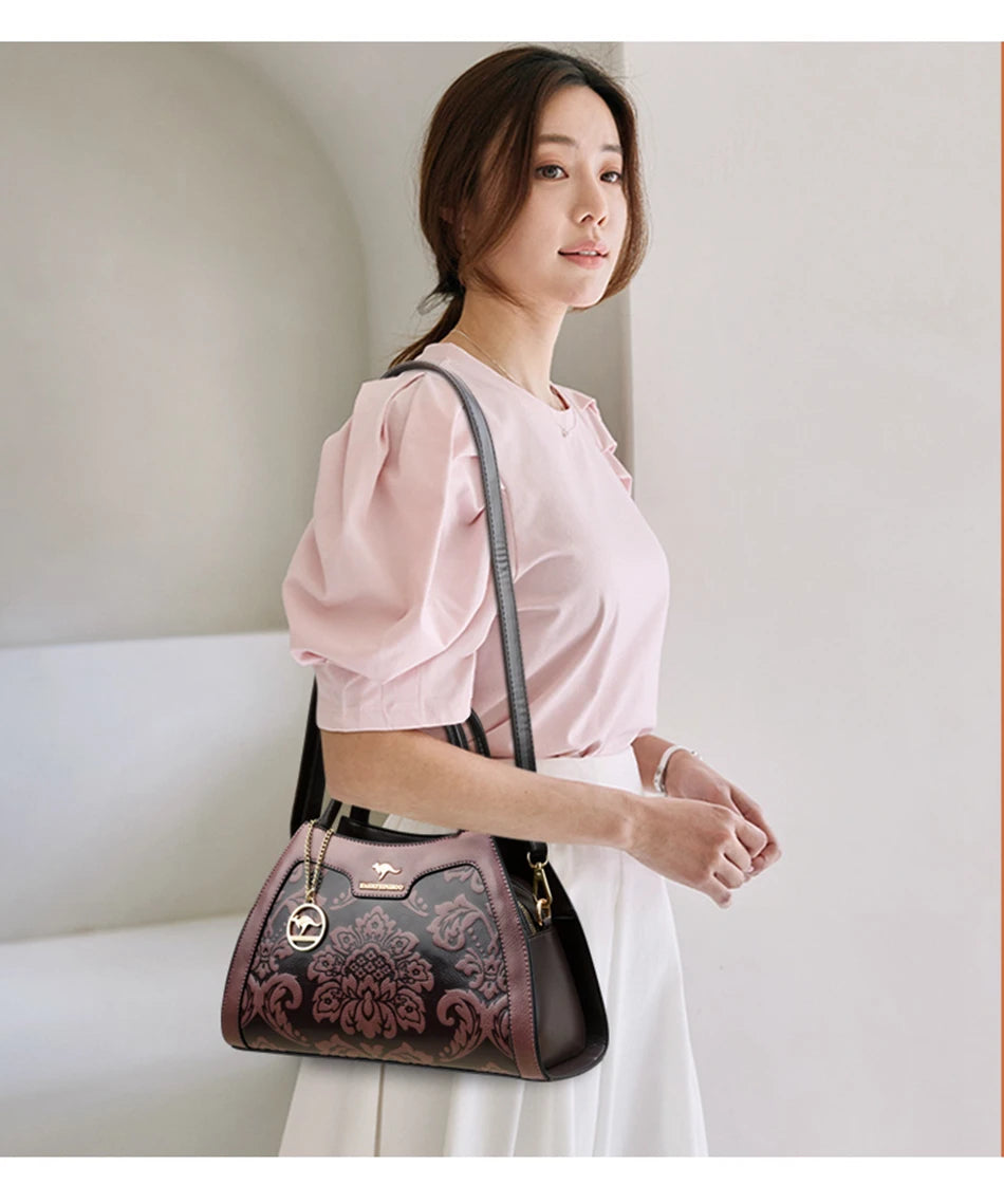 Woman holding a decorative handbag against a plain background