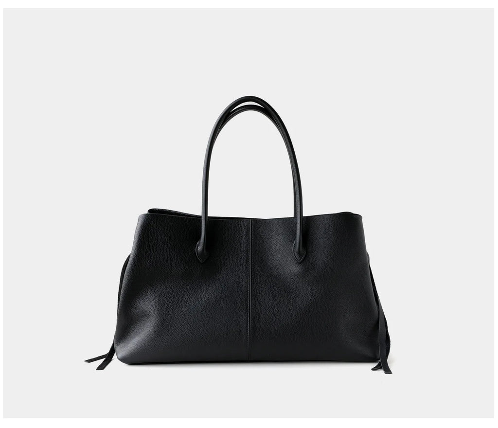 Black handbag on a light gray background