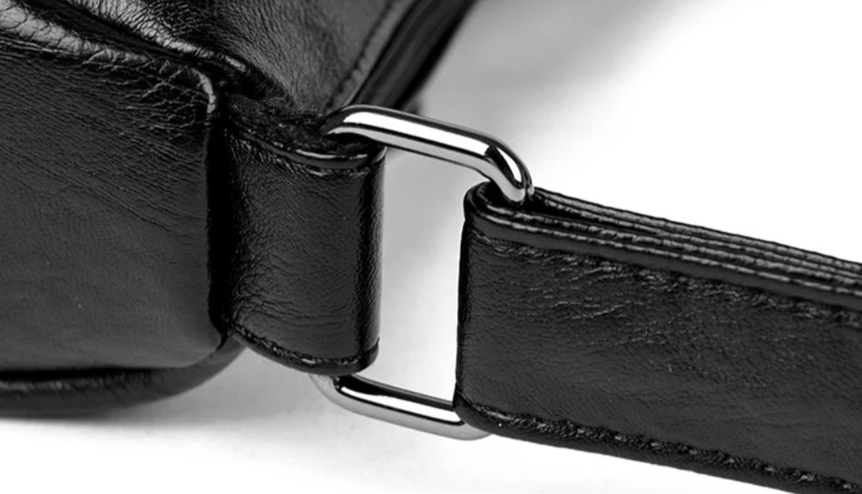 Close-up of a black leather strap with a metal buckle on a white background