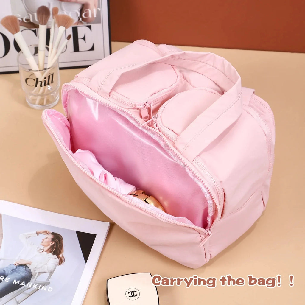 Pink backpack on a beige surface with visible brand name