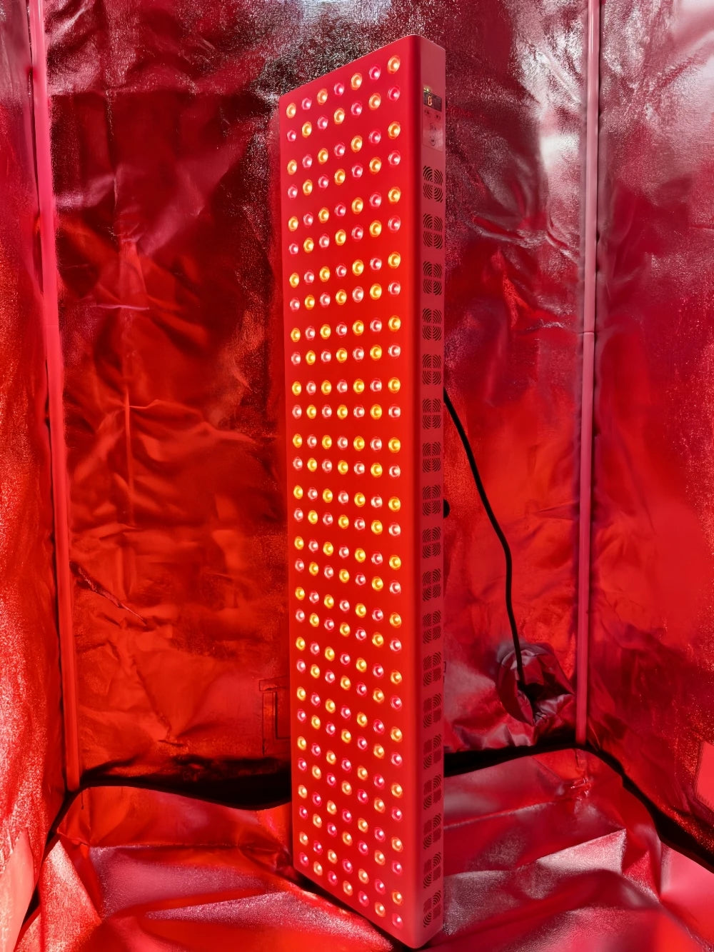 Red LED light panel inside a red reflective tent