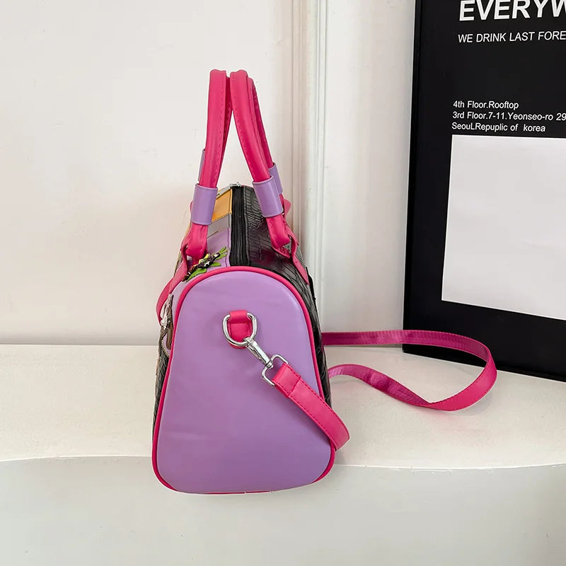 Purple and pink pet carrier with a leash on a white surface.
