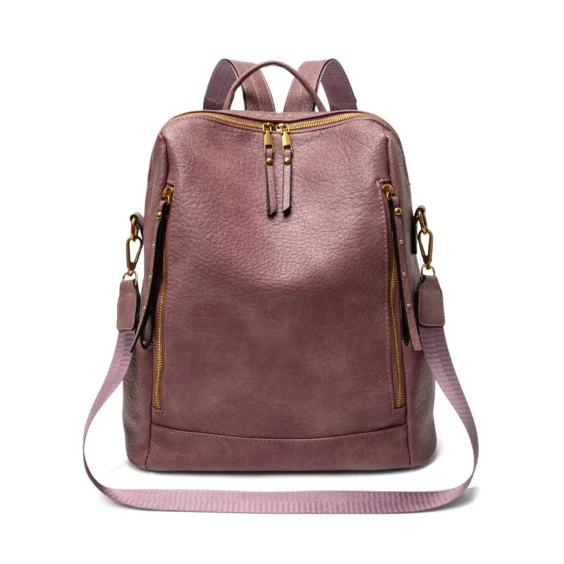 Pink backpack with gold zippers on a white background