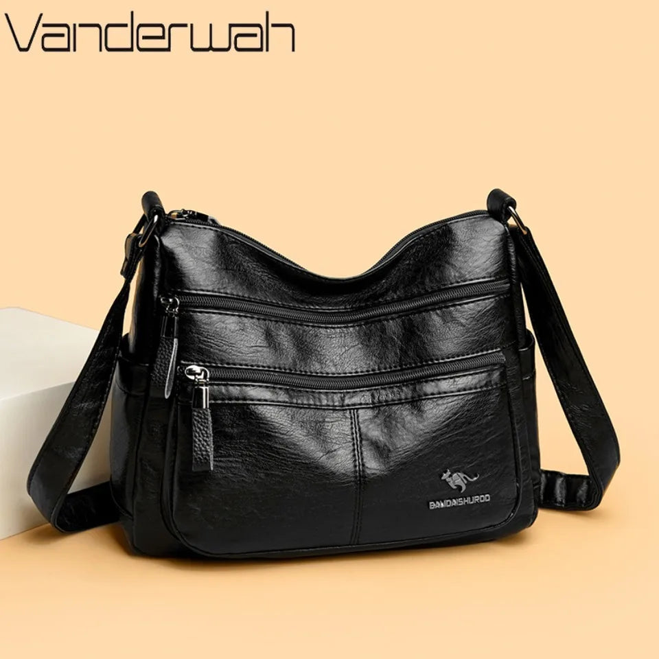 Black handbag with multiple pockets and a visible brand logo on a beige background