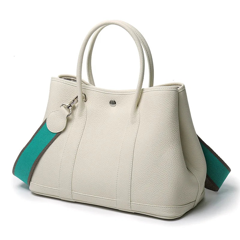 White handbag with turquoise accents on a white background