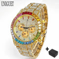 A gold-tone UNIGUET watch covered in clear rhinestones, featuring a colorful rainbow crystal bezel and a gold-tone dial with three subdials. A small black accessory box is shown in the bottom right corner against a white background.