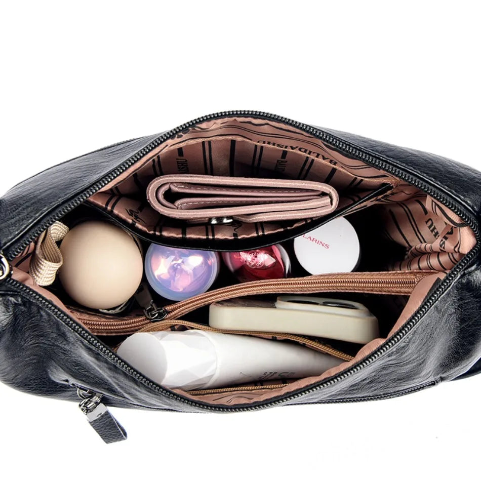 Open makeup bag with various cosmetic items on a white background