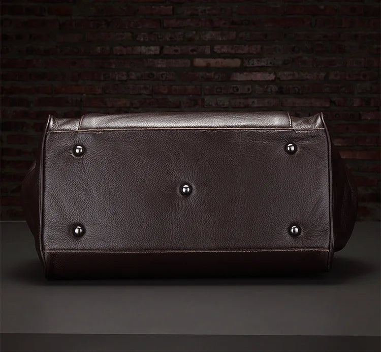 Brown leather bag with silver studs on a dark background