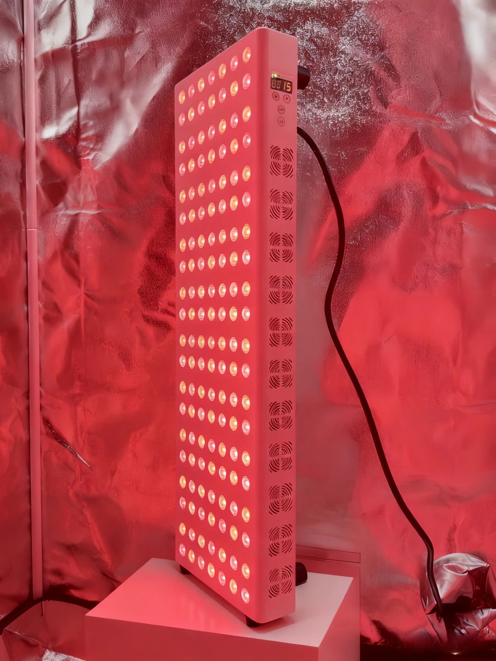 Red LED grow light on a stand with a red background