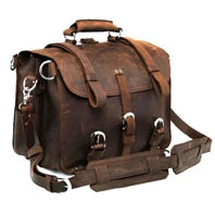 Brown leather satchel bag with straps on a white background