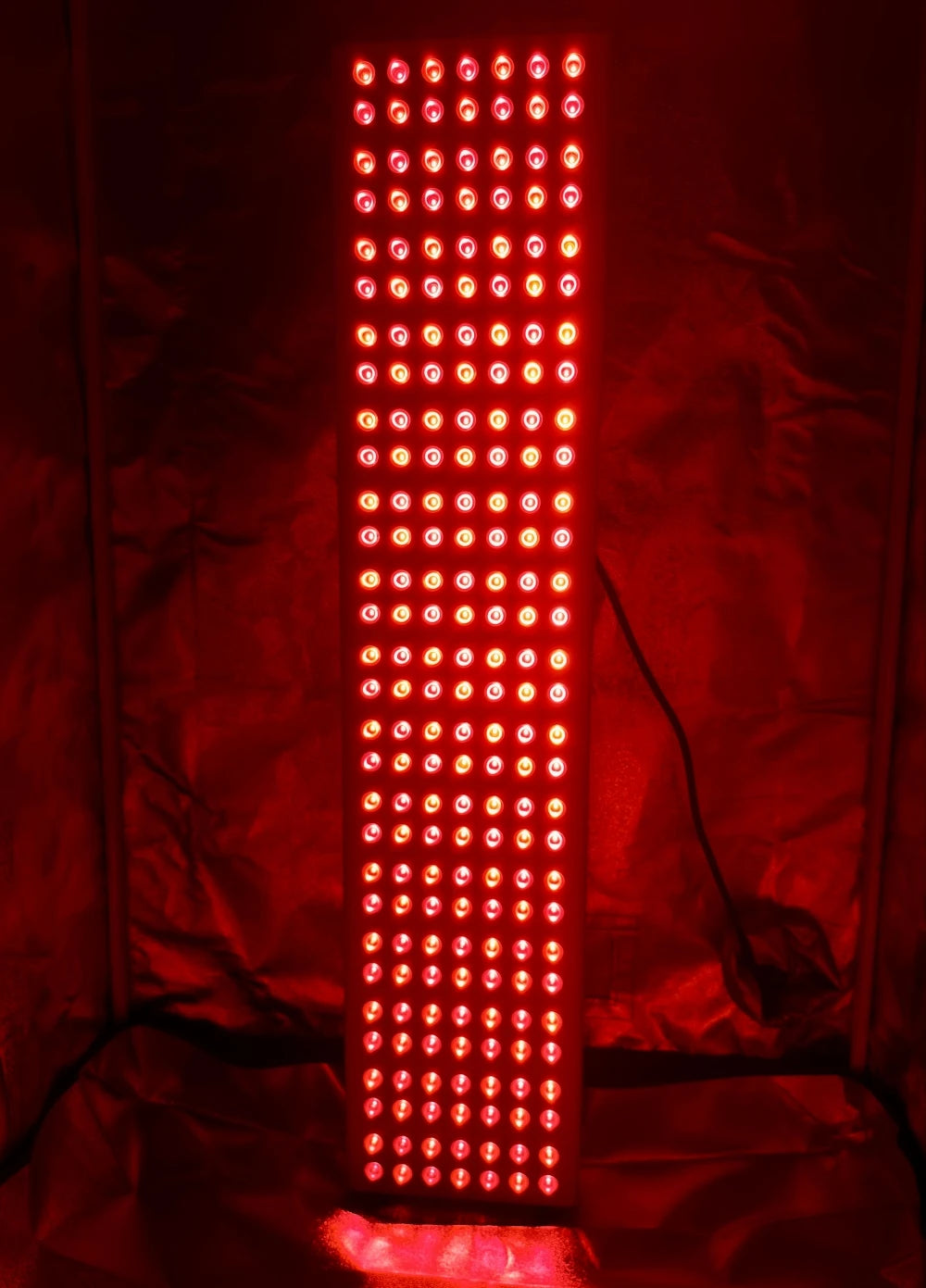 Red LED light panel on a dark background