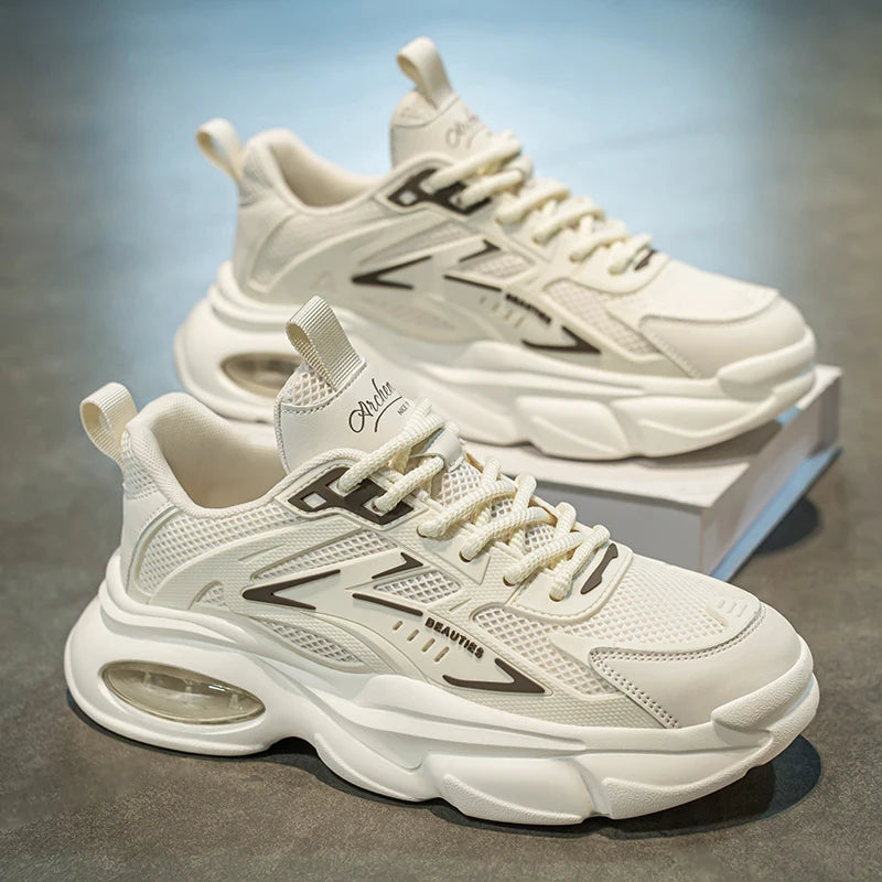 White sneakers with brand logo on a gray surface