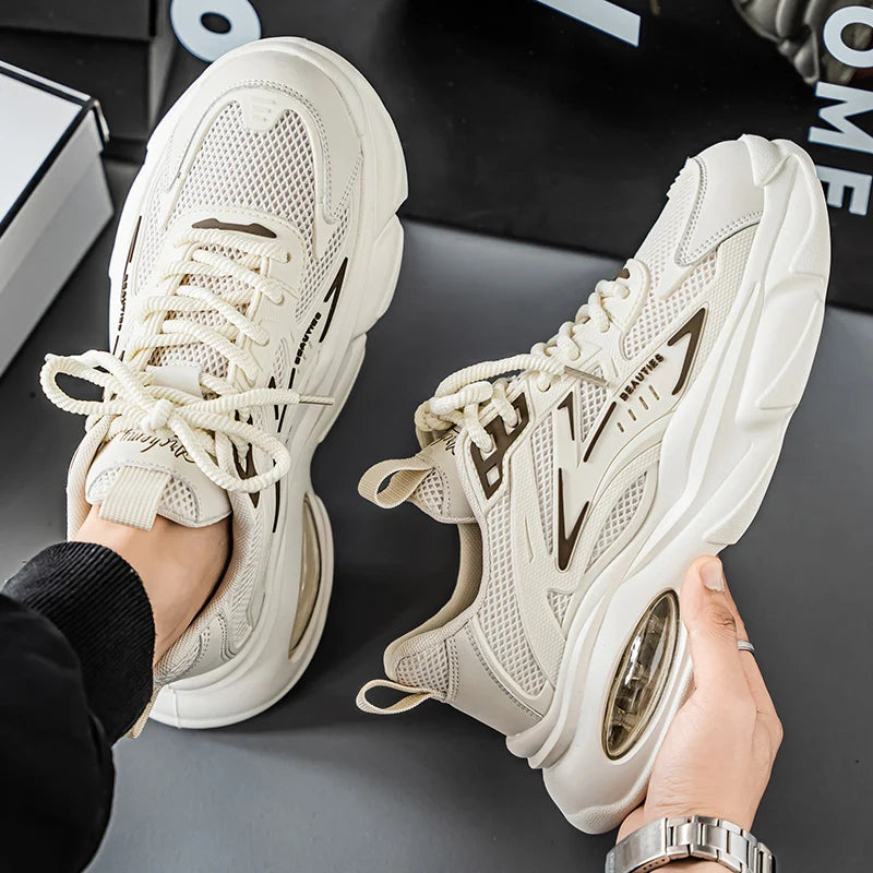 White sneakers being held on a dark surface