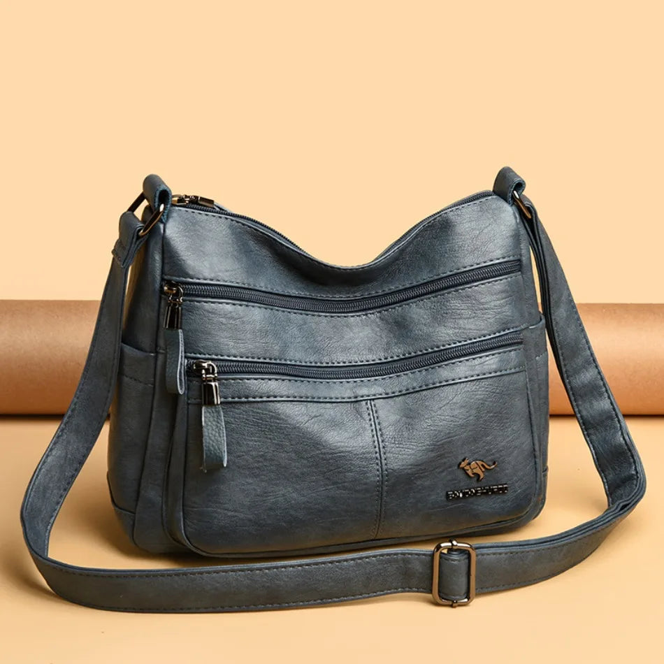Blue handbag with a strap on a beige background