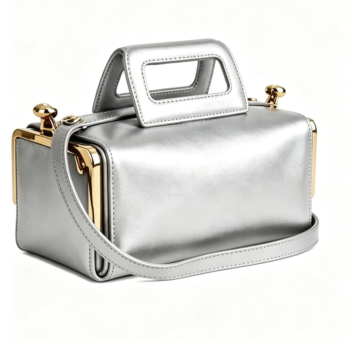 A metallic silver cosmetic bag with a top handle, shoulder strap, and gold-tone hardware, shown on a clean white background.