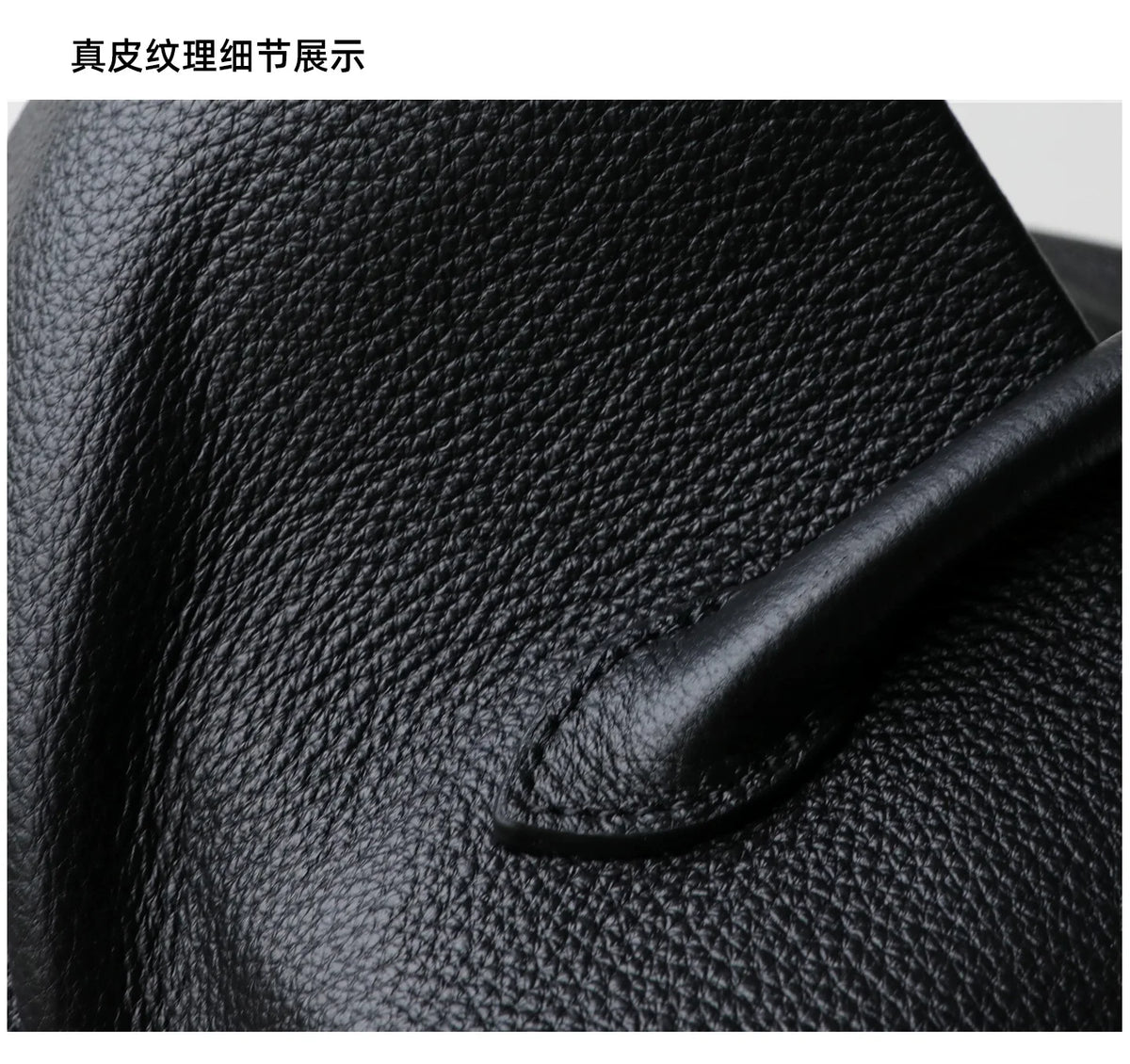 Close-up of black leather texture with a pen on top