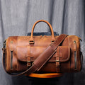 Brown leather duffel bag with shoulder strap on a gray background