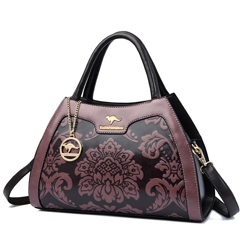 Purple patterned handbag with gold accents on a white background