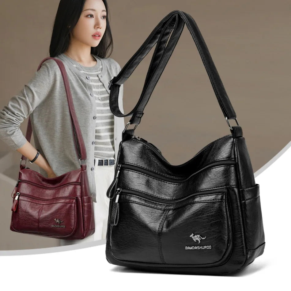 Black leather handbag with a woman holding a red handbag in the background