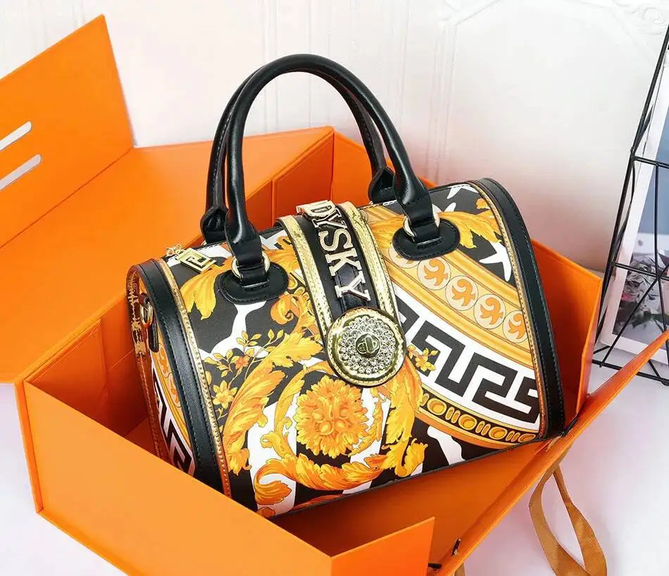 Designer handbag with floral pattern in an open orange box