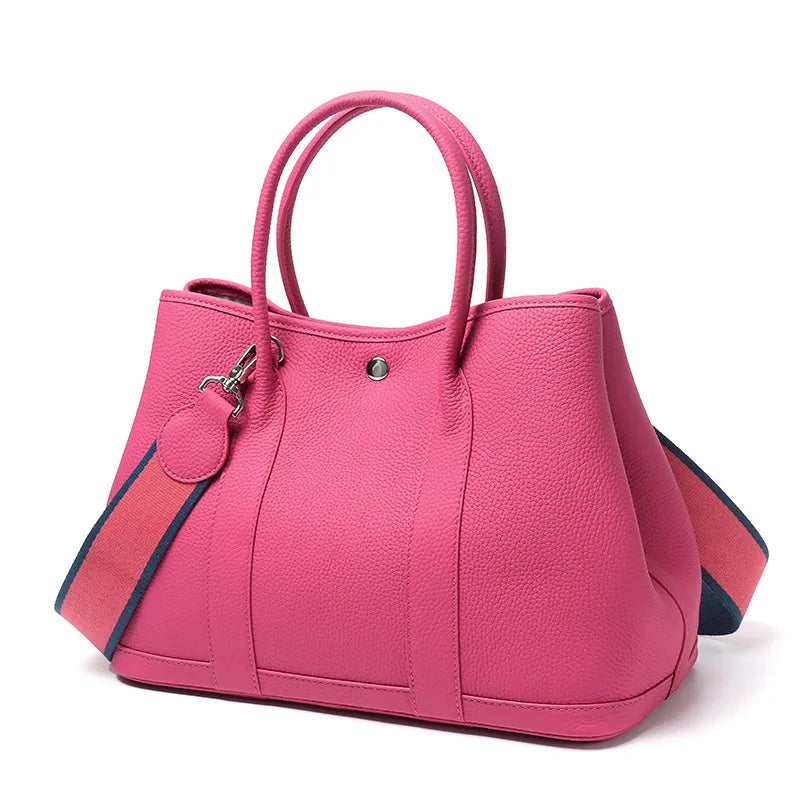 Pink handbag with a strap on a white background