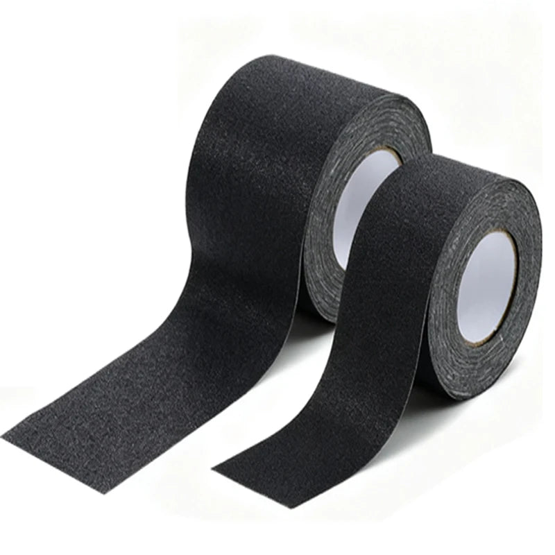Two rolls of black textured adhesive tape with white inner cores, shown on a clean white background.