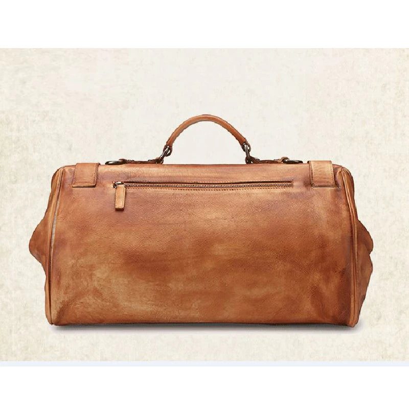 Brown leather duffel bag on a beige background