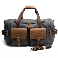 Gray duffel bag with brown leather accents on a white background