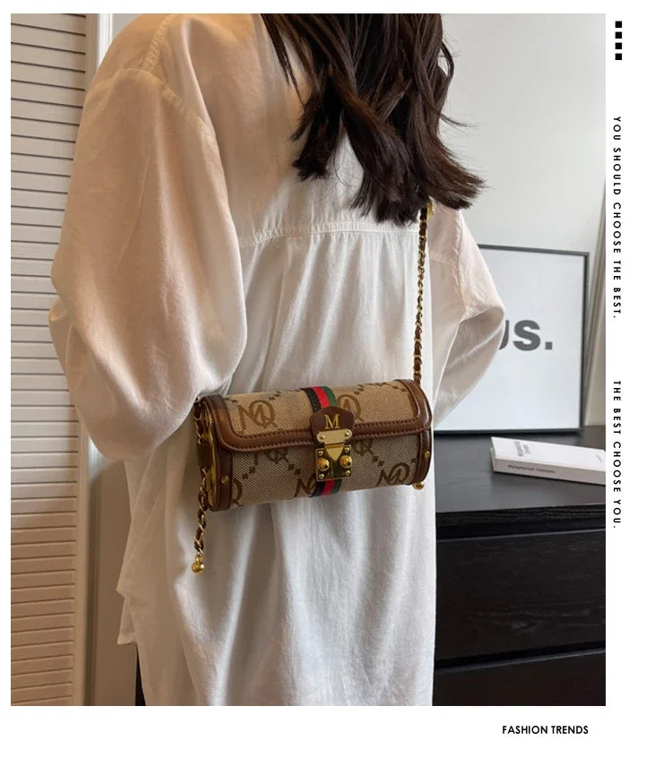 Person wearing a beige dress holding a patterned handbag indoors.