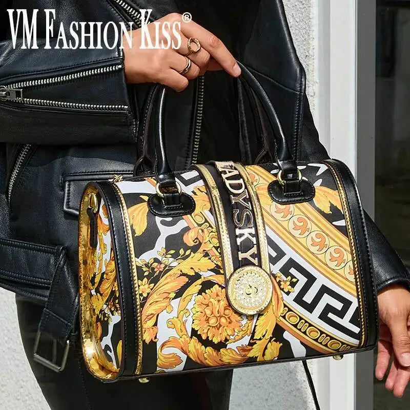 Person holding a Versace handbag with intricate design and 'VM Fashion Kiss' branding.