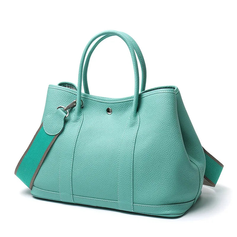 Turquoise handbag on a white background