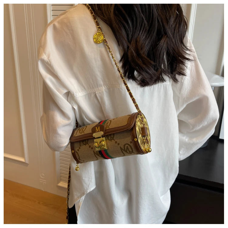 Person wearing a white shirt with a patterned handbag over their shoulder.