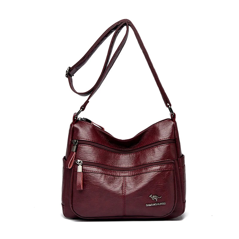 Maroon handbag with a strap on a white background