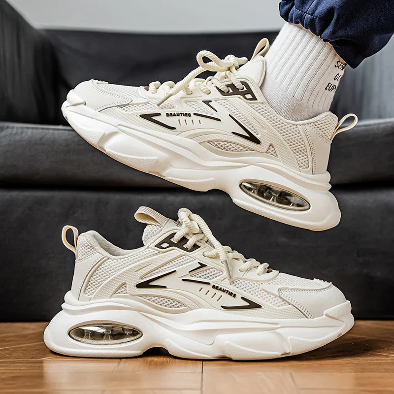 White sneakers with black accents on a wooden floor and gray couch background