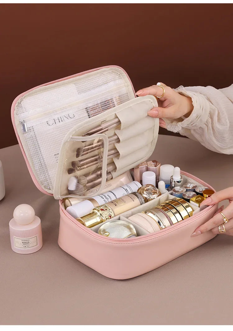 Pink cosmetic case with skincare products on a brown background