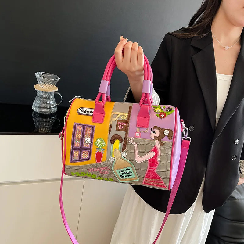 Person holding a colorful handbag with artistic design