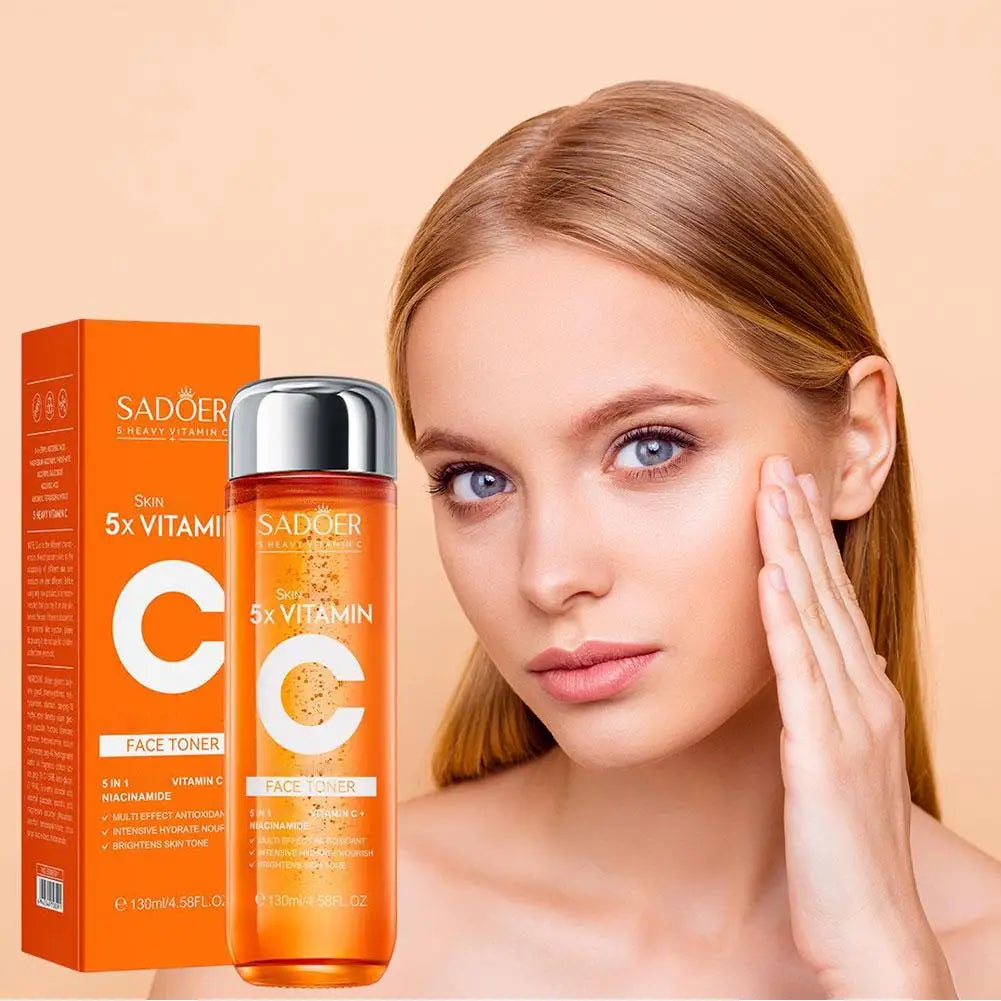 Woman with smooth skin holding her face next to SADOER Vitamin C skincare products on a beige background