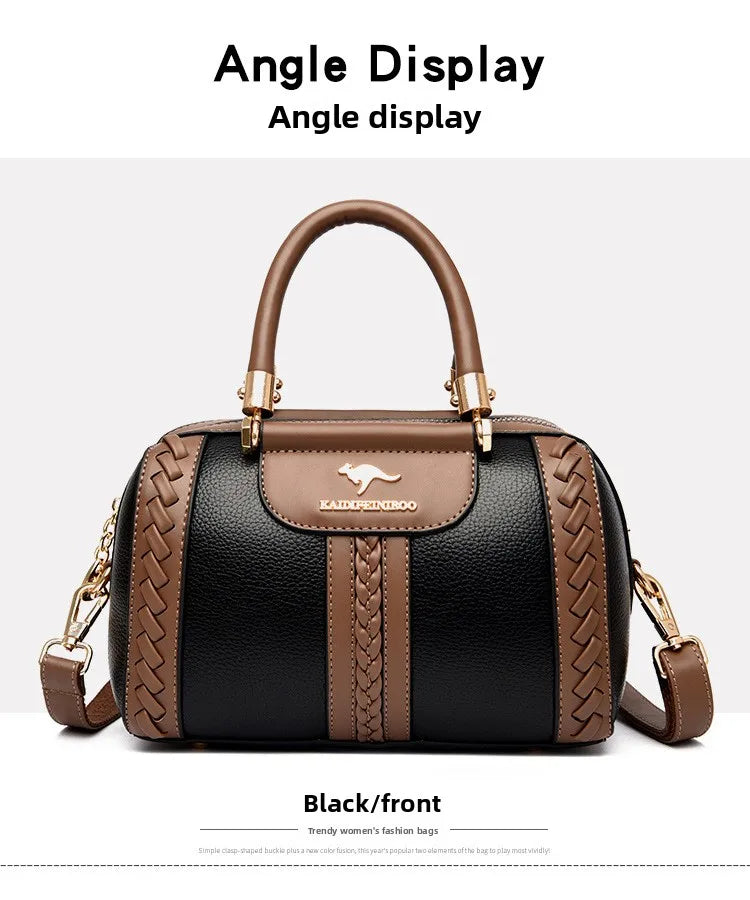 A structured handbag shown from the front with text labels reading 'Angle display' at the top and 'Black/front' at the bottom. The bag is black pebbled leather with brown trim, braided side panels, double top handles, and a detachable shoulder strap.