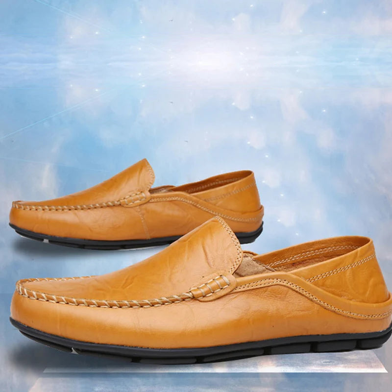 Pair of tan loafers on a light blue textured background