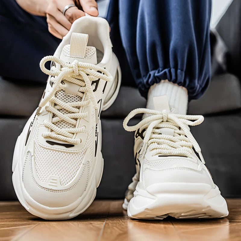 White sneakers being worn on a wooden floor with a blurred background