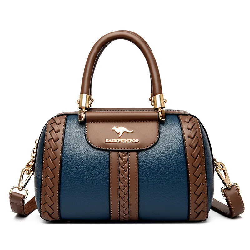 Blue handbag with brown accents and a visible brand logo on a white background