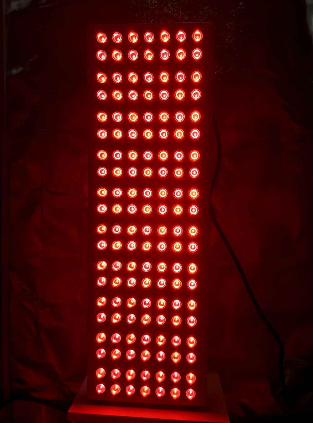 Red LED light panel on a dark background