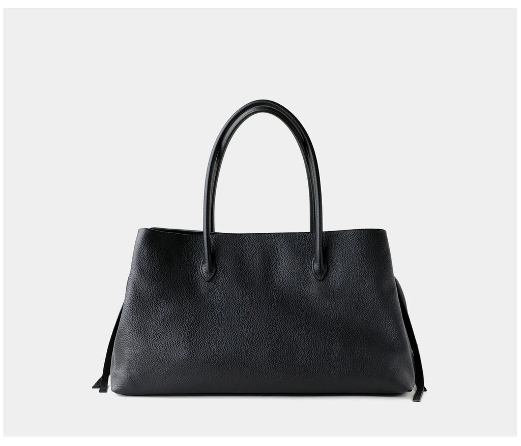 Black handbag on a light gray background