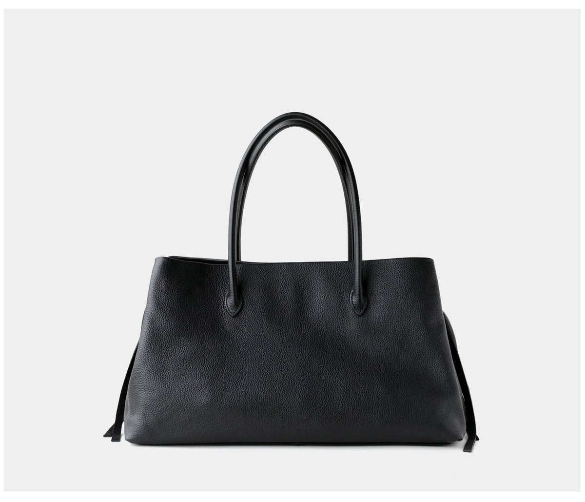 Black handbag on a light gray background