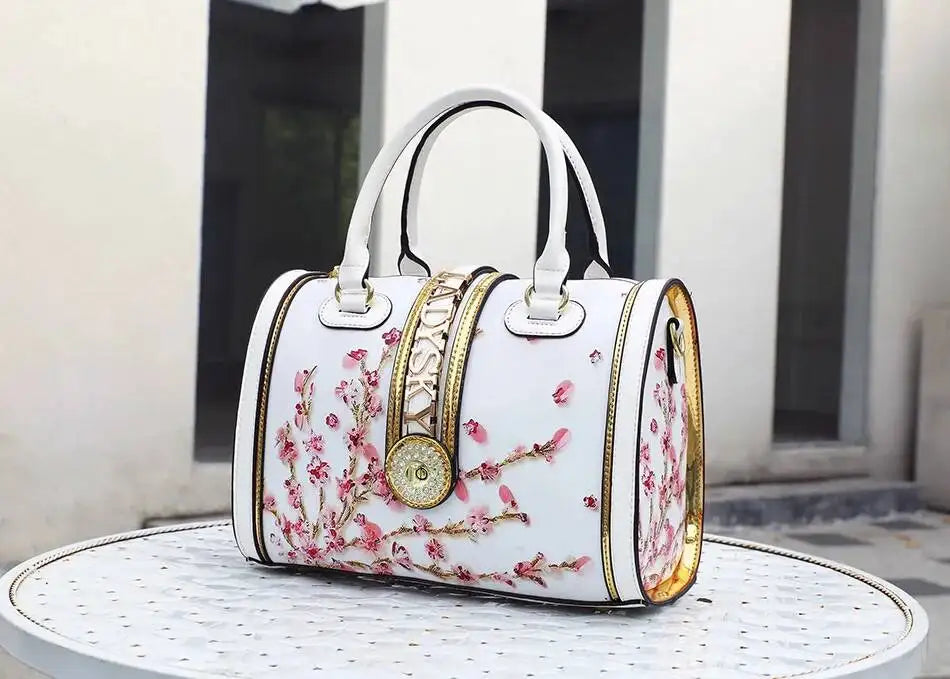 White handbag with floral design on a round table